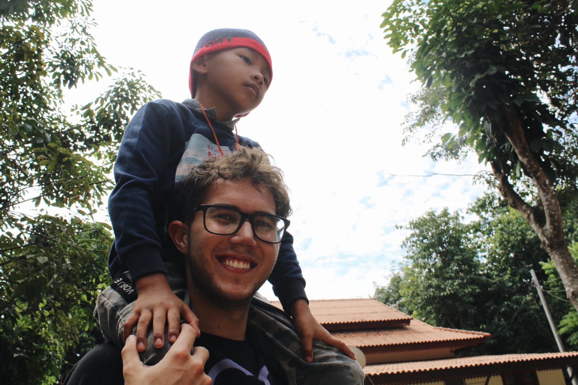 Team member carrying a child on his shoulders