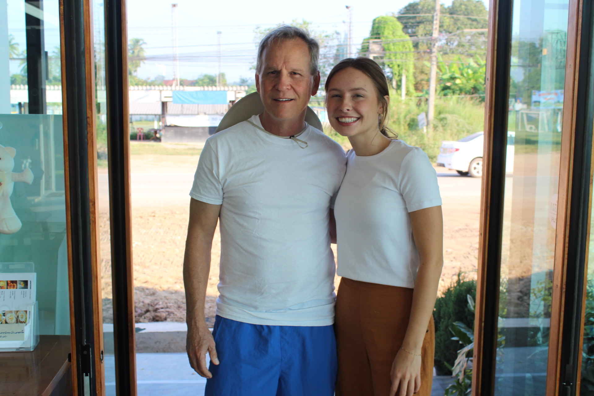 Two team members at the doorway of the school